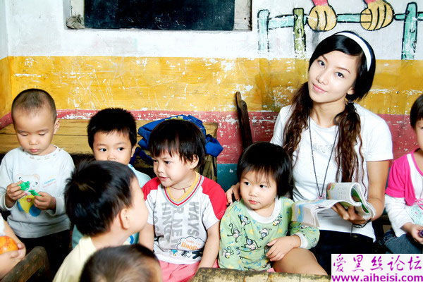 美丽温柔的幼儿园老师展示出自己与小朋友的照片
